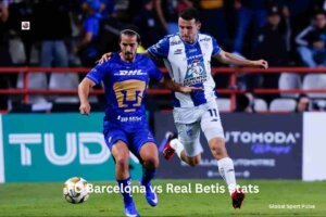 Alt text: Players from Pachuca and Pumas UNAM competing for the ball during a competitive Liga MX match in a packed stadium.